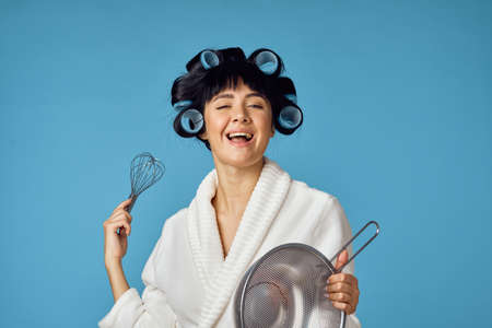 housewife in white coat housework cleaning blue backgroundの写真素材