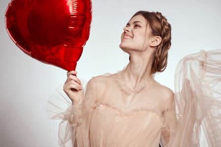 portrait of a woman in a dress balloon Valentines Day light backgroundの写真素材