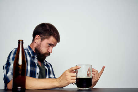 drunk man drinking beer alcohol emotion light backgroundの写真素材