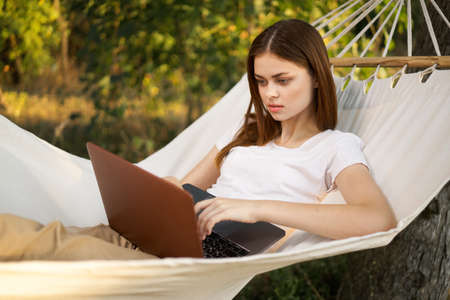 woman love with laptop on nature vacation work travelの写真素材