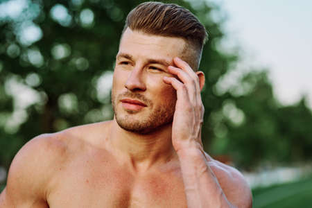 man with pumped up muscular body outdoors health workoutの写真素材