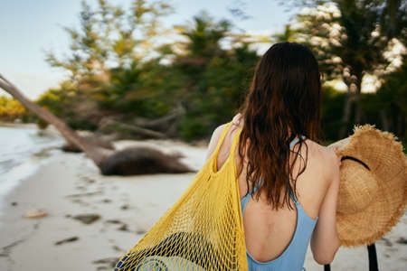 woman wearing sunglasses blue swimsuit island beach sunの写真素材