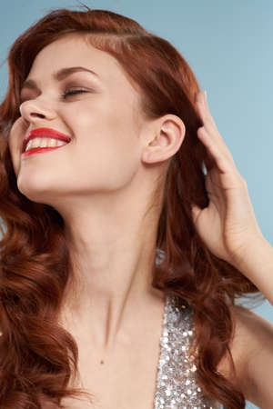 attractive red-haired woman red lips face close upの写真素材