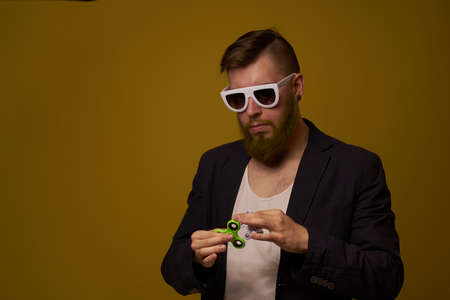 man wearing sunglasses spinner in hands fashion posing black jacketの写真素材