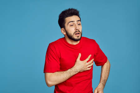 man in red t-shirt health problems emotions symptoms blue backgroundの写真素材