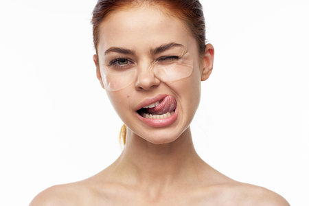 cheerful woman bare shoulders clear skin face maskの写真素材