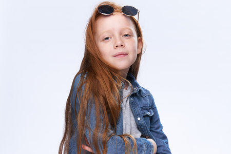 fashionable girl posing studio lifestyle light backgroundの写真素材