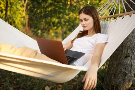 woman love with laptop on nature vacation work travelの写真素材