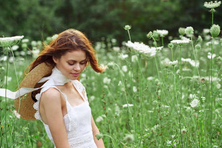 pretty woman in white dress in a field flowers natureの写真素材