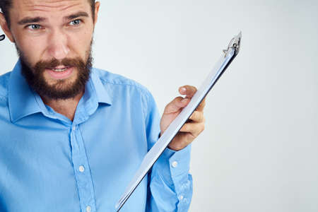 bearded man in blue shirt documents manager professionalの写真素材