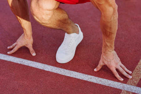 athletic man doing exercises outdoors sports field exercise