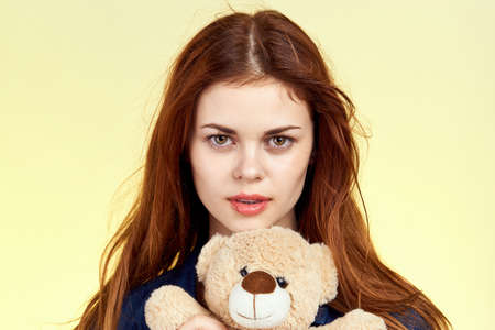 cheerful woman with teddy bear fashion posing holidayの写真素材