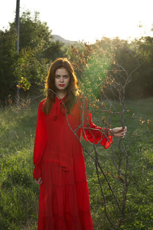 attractive woman in red dress outdoors fresh air summerの写真素材