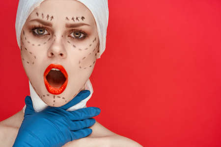 portrait of a woman Red lips plastic surgery operation bare shoulders red backgroundの写真素材