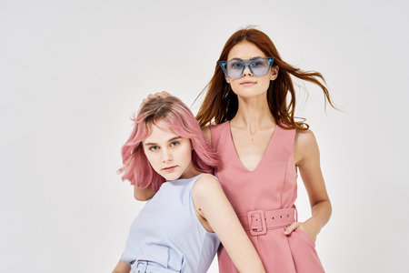 two girlfriends standing side by side posing fashion luxury