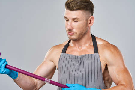 a man with a mop in his hands cleaning service posingの写真素材