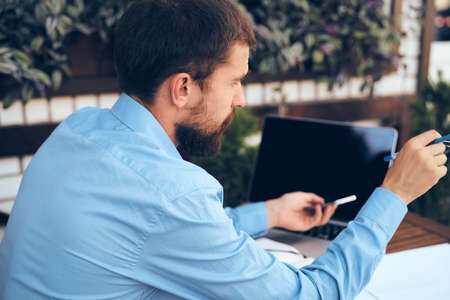business man outdoors with laptop in cafe emotionsの写真素材