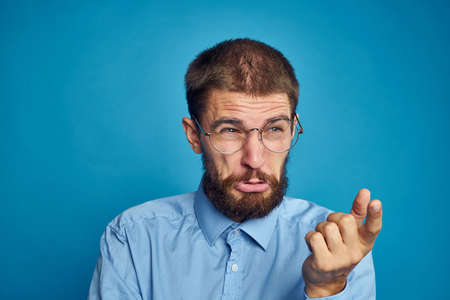 business man with glasses emotions blue backgroundの写真素材