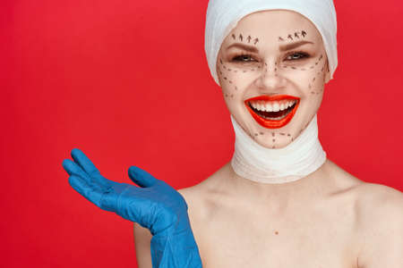 a person Red lips plastic surgery operation bare shoulders red backgroundの写真素材