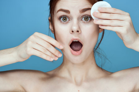 woman with bare shoulders cotton pads hygiene skin careの写真素材