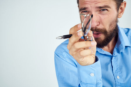 bearded man in blue shirt documents manager professional