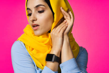 muslim woman with smart watch technology posing pink backgroundの写真素材