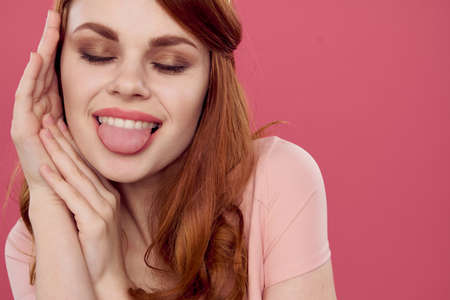 pretty woman posing cosmetics charm pink backgroundの写真素材