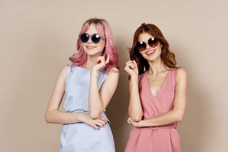 two girlfriends stand side by side dress luxury summer posingの写真素材