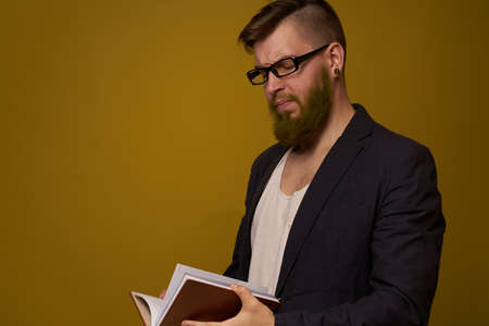 business man with glasses notepad in the hands of a studio officialの写真素材