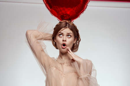 portrait of a woman Birthday party gift heart balloon light backgroundの写真素材