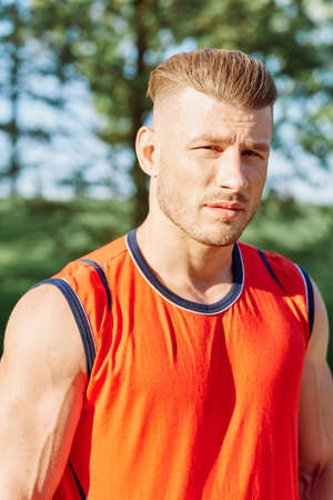 sporty man in the morning in the park with dumbbells exerciseの写真素材
