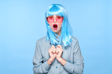 cheerful glamorous woman in pink glasses purple wig fashionの写真素材