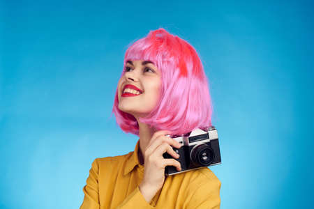 pretty woman with pink hair photographer with camera creative professionの写真素材
