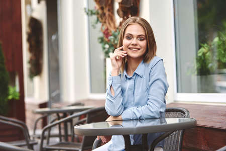 Business woman in a cafe in the summer outdoors on vacationの写真素材