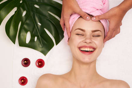 cheerful woman burnt pension towel spa treatments green leafの写真素材