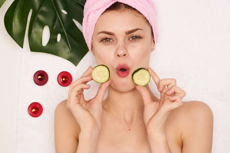 cheerful woman pink towel on her head spa treatments facial maskの写真素材