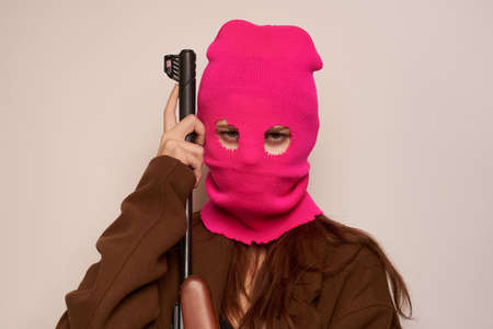woman in pink mask danger crime fashion isolated backgroundの写真素材