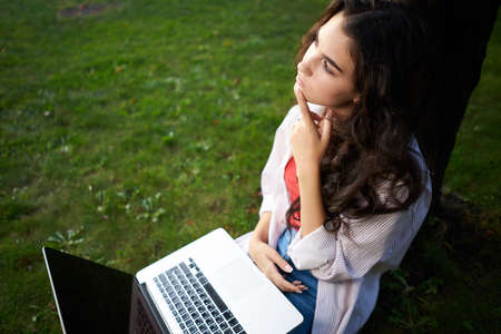 woman in the park sitting on the grass Lifestyleの写真素材