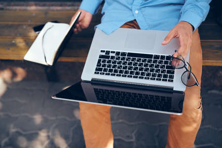 man with laptop outdoors in the parkの写真素材