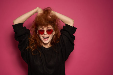 pretty woman charm cosmetics posing smile pink backgroundの写真素材