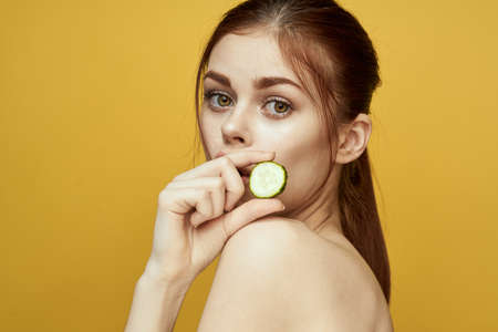 cheerful woman with cucumber vitamin skin care natural productの写真素材