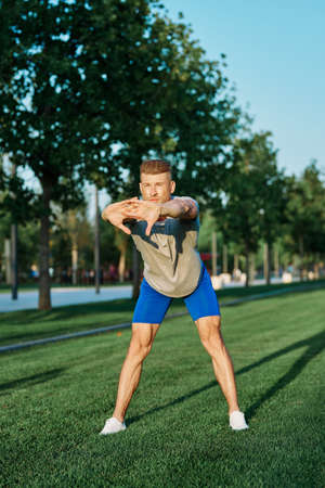 sporty man in the park on the lawn exercise lifestyleの写真素材