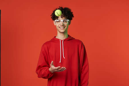 guy in red sweater posing heart holiday isolated backgroundの写真素材