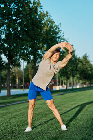 sporty man in the park on the lawn exercise lifestyleの写真素材