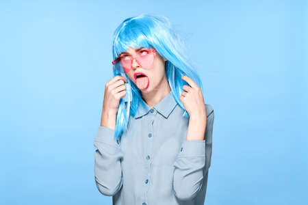 cheerful glamorous woman in pink glasses purple wig fashionの写真素材