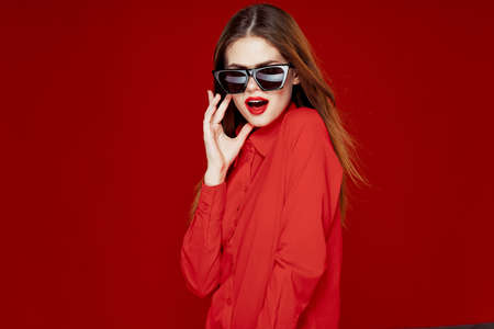 glamorous woman wearing sunglasses red shirt hairstyle modelの写真素材