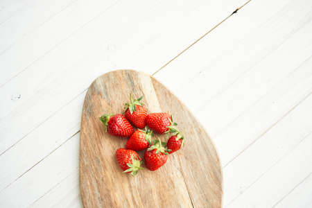 fresh strawberries on wooden board fruit vitamins summerの写真素材