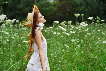 Woman in white dress and hat in a field with flowers lifestyle