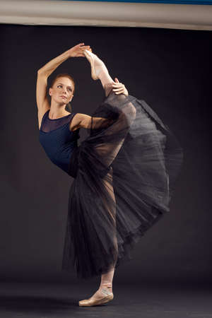 pretty woman silhouette of a woman performance grace dark backgroundの写真素材