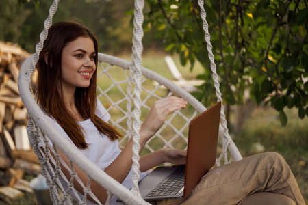cheerful woman outdoors laptops communication internet recreationの写真素材
